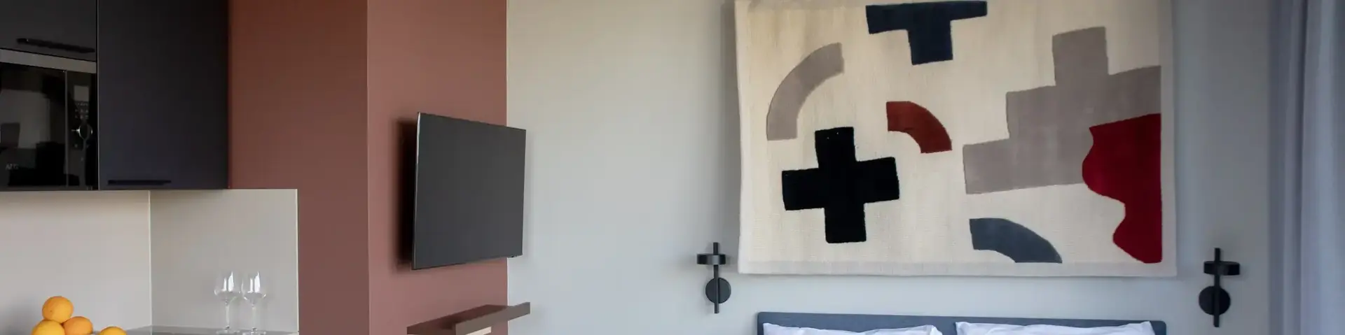 a bedroom with a bed and a tv