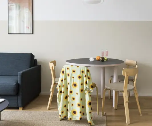 a table with chairs and a blanket on it