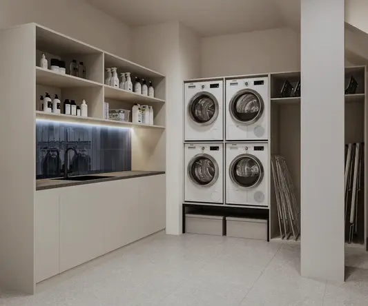 a laundry room with white cabinets and white countertops