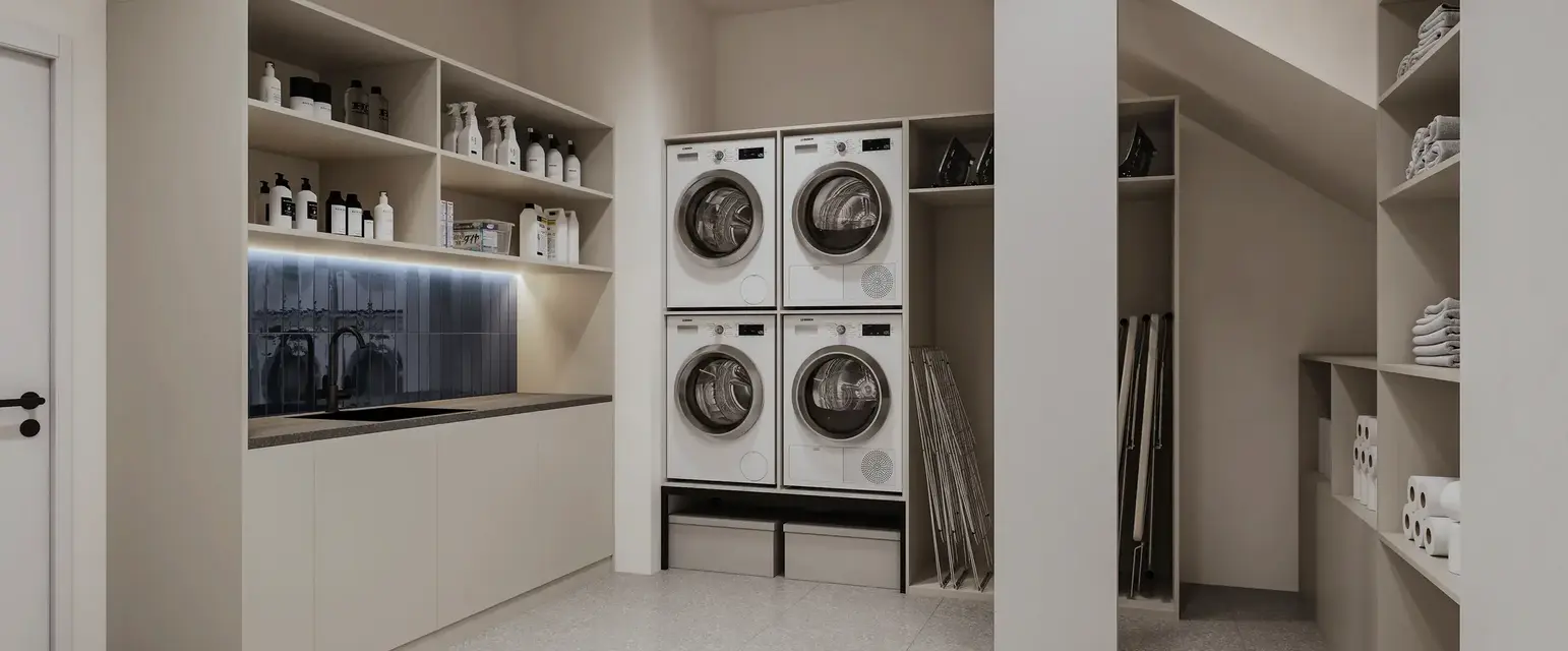 a laundry room with white cabinets and white countertops