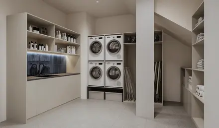 a laundry room with white cabinets and white countertops