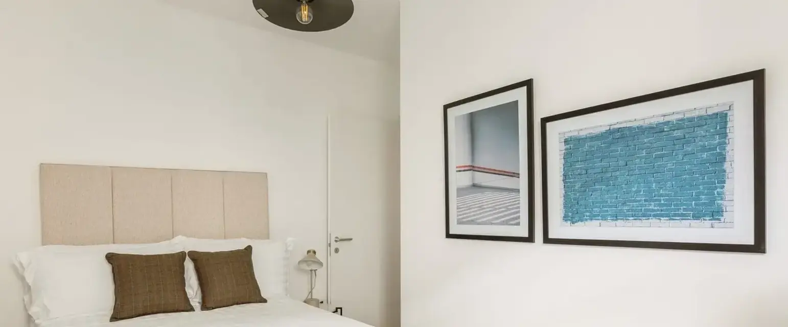 a bed with pillows in a room