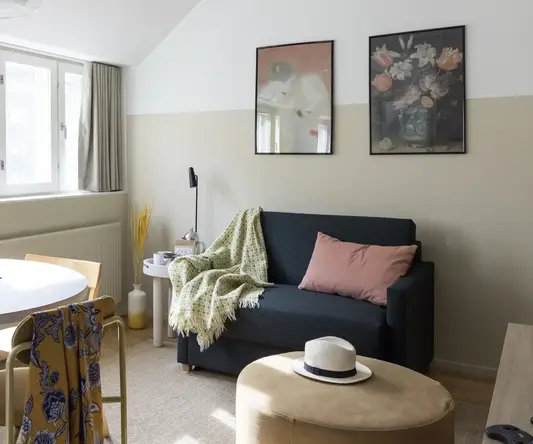 a living room with a couch and a round table