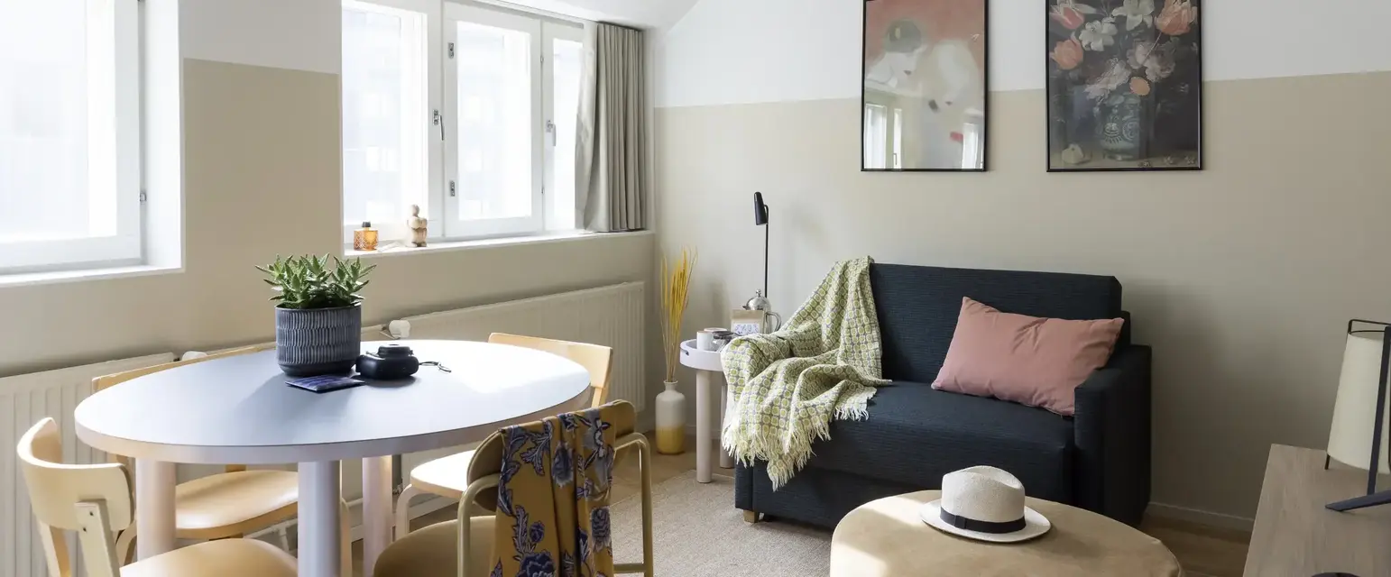 a living room with a couch and a round table