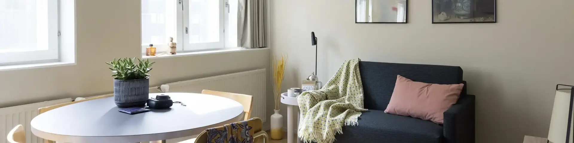 a living room with a couch and a round table