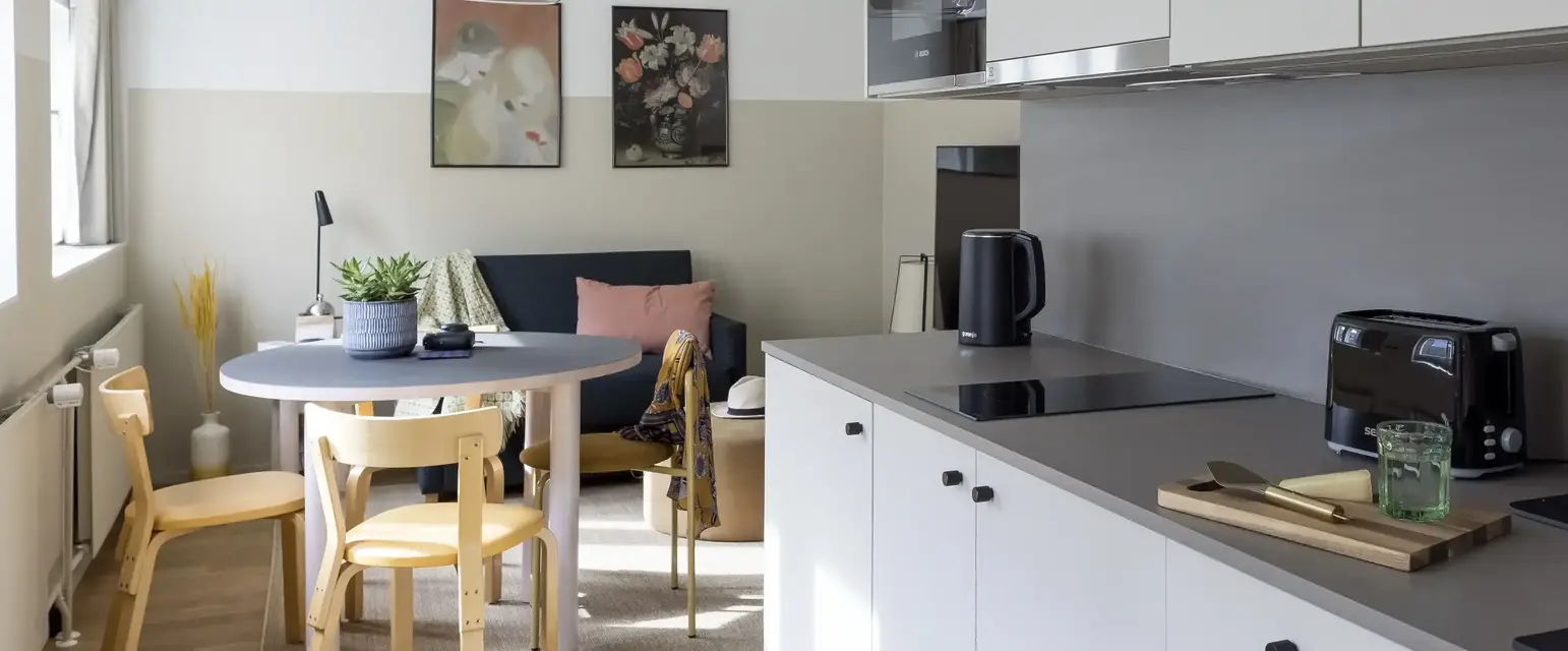 a kitchen with a table and chairs