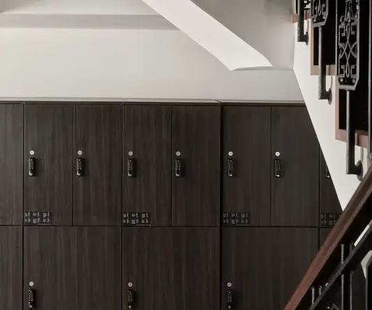 a staircase with black metal railings and lockers