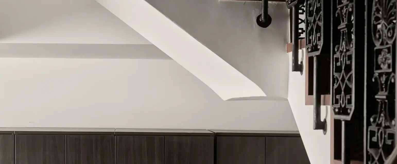 a staircase with black metal railings and lockers