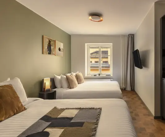 a room with two beds and a television