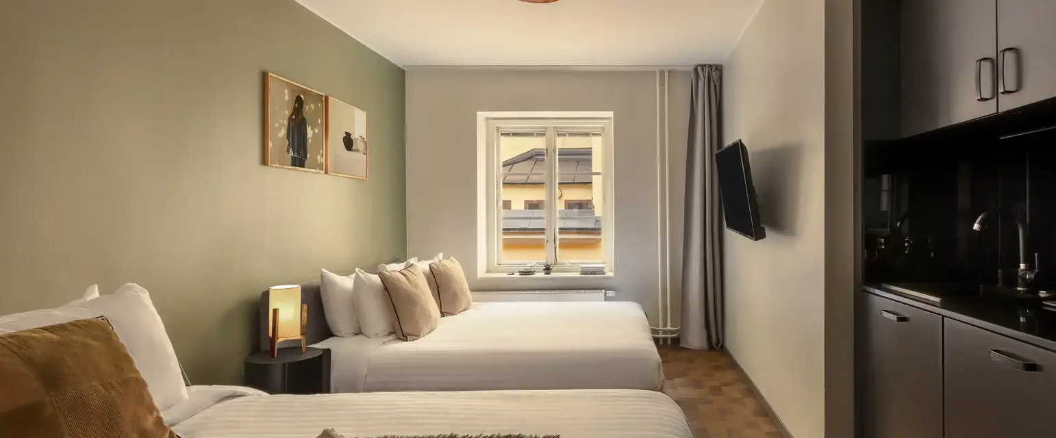 a room with two beds and a television