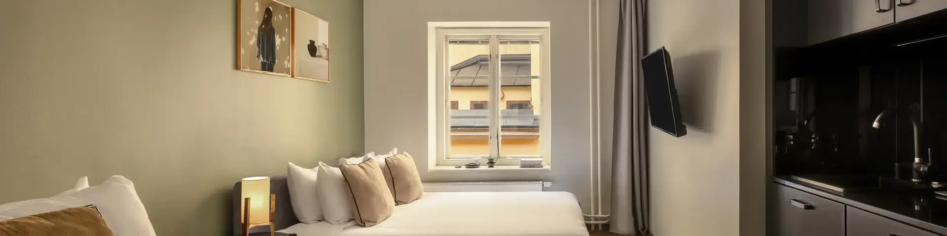 a room with two beds and a television