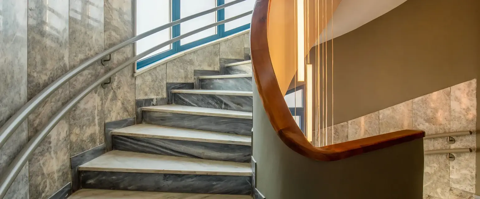 a staircase with a curved railing