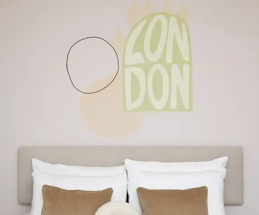a bed with pillows and a wall art