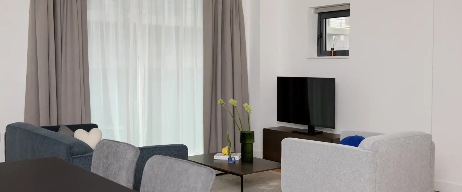 a living room with a tv and a table