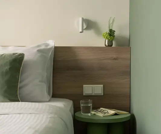 a side table next to a bed