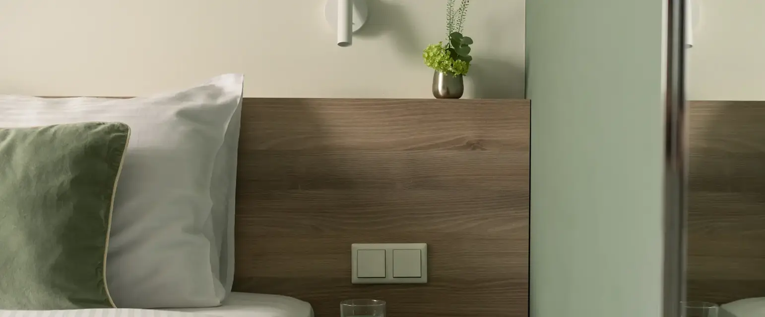 a side table next to a bed