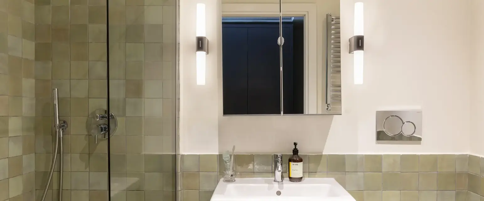 a bathroom with a mirror and sink