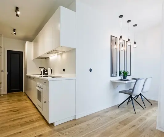 a kitchen with a table and chairs