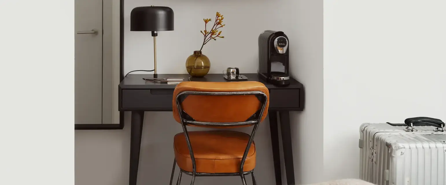 a desk with a chair and a tv on the wall