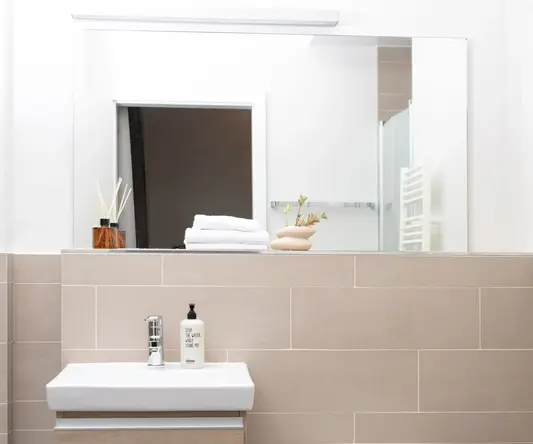 a bathroom with a mirror and sink