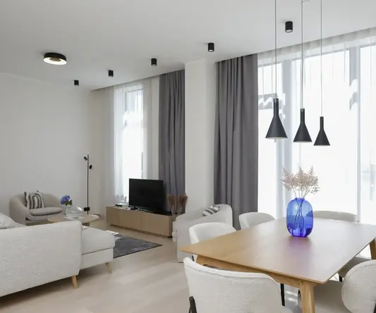 a living room with a table and chairs