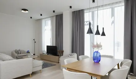 a living room with a table and chairs