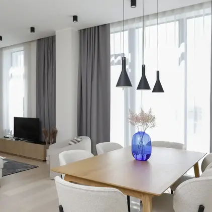 a living room with a table and chairs