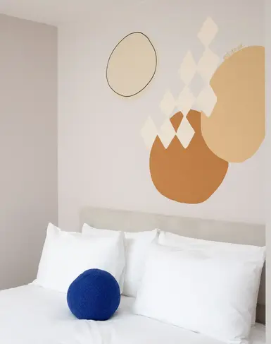 a bed with pillows and a ball on it