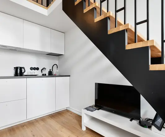 a staircase with a tv and a coffee maker