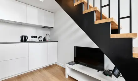 a staircase with a tv and a coffee maker