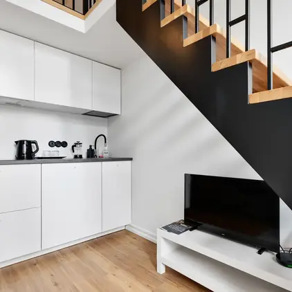 a staircase with a tv and a coffee maker