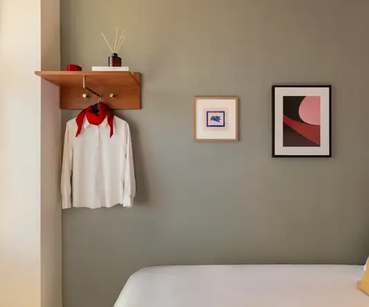 a room with a bed and a picture on the wall