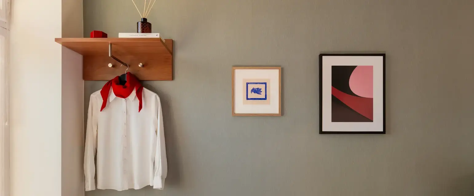 a room with a bed and a picture on the wall