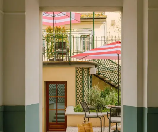 a patio area with chairs and umbrellas