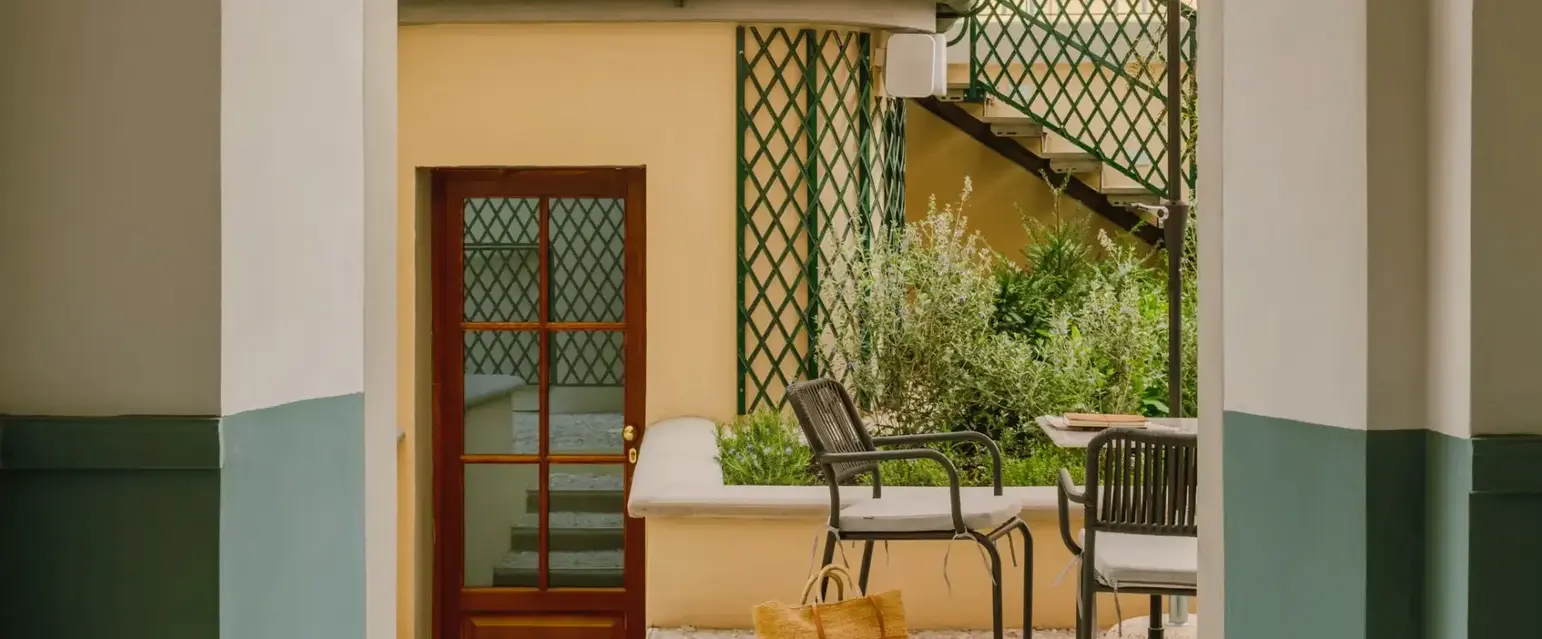 a patio area with chairs and umbrellas