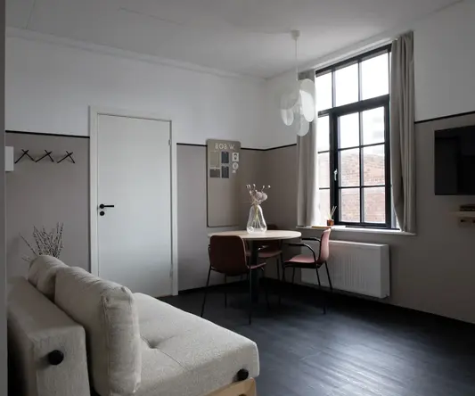 a room with a table and chairs