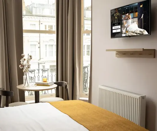 a room with a bed and a tv on the wall
