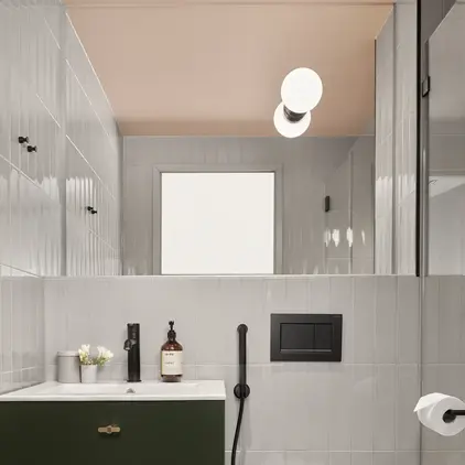 a bathroom with a green sink and toilet