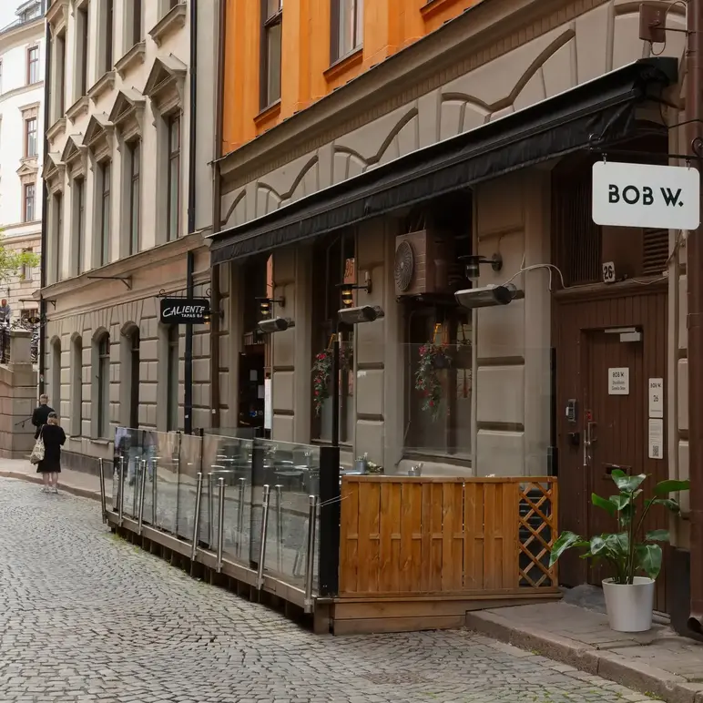 a street with a building and a sign