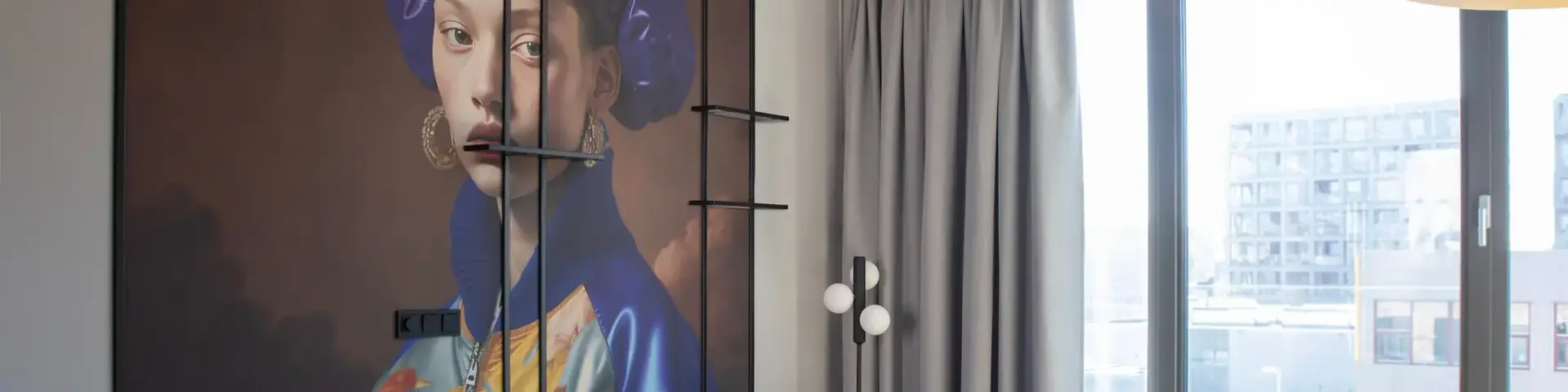 a room with a couch and a painting on the wall