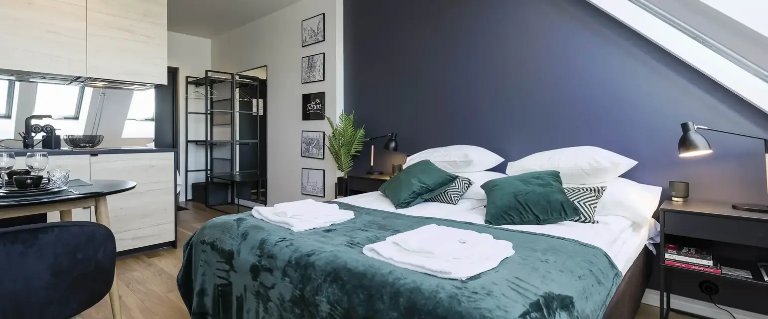 a bedroom with a bed and a ceiling fan