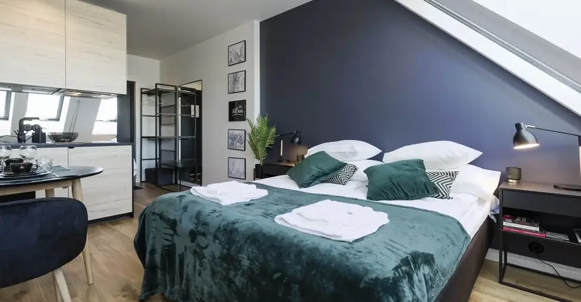 a bedroom with a bed and a ceiling fan