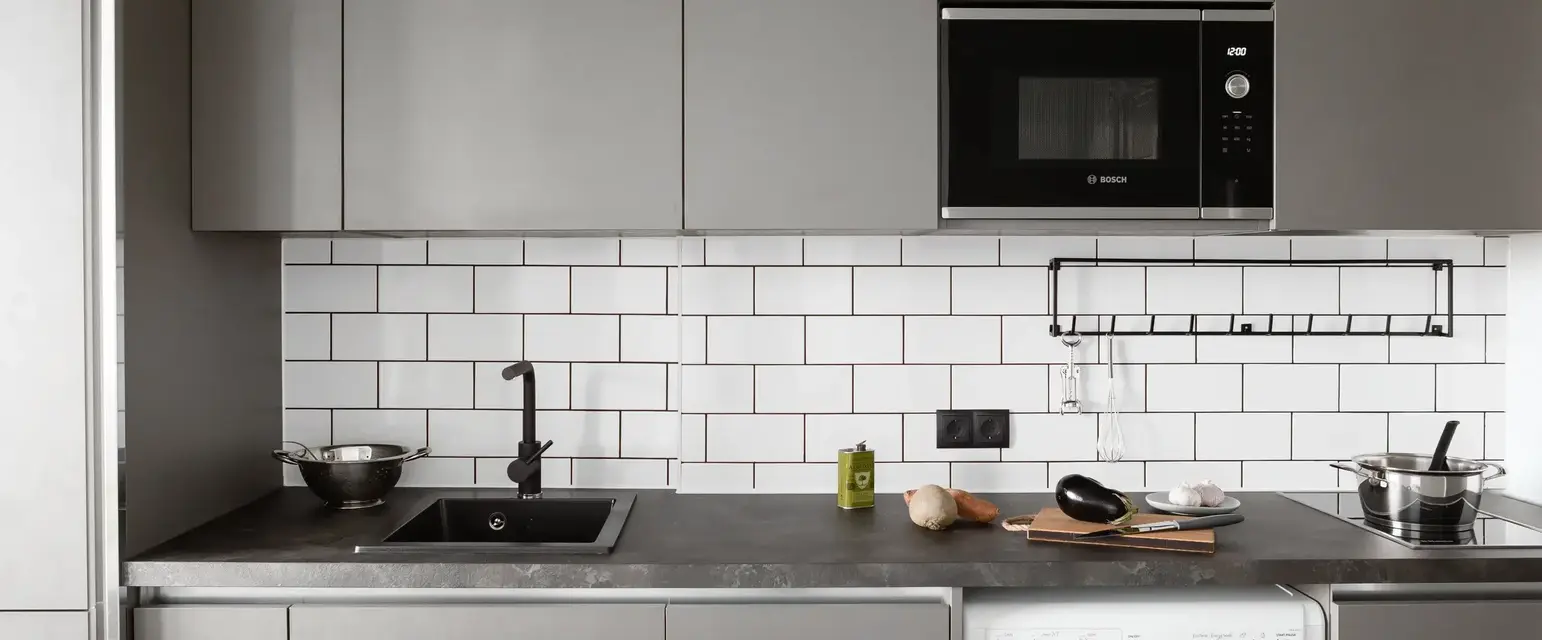 a kitchen with a microwave and a washing machine
