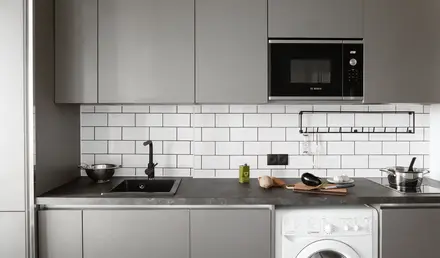 a kitchen with a microwave and a washing machine