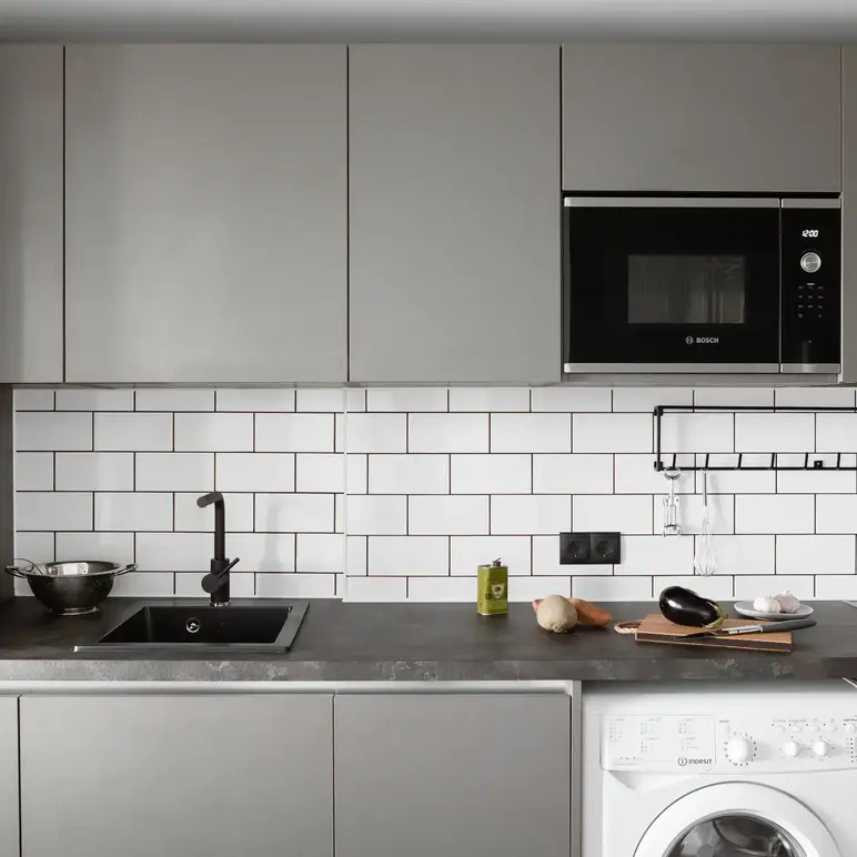 a kitchen with a microwave and a washing machine