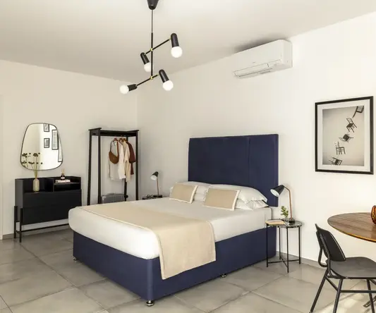 a bedroom with a bed and a mirror