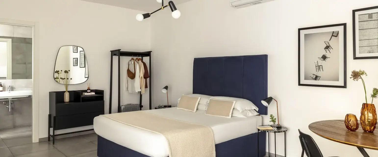a bedroom with a bed and a mirror