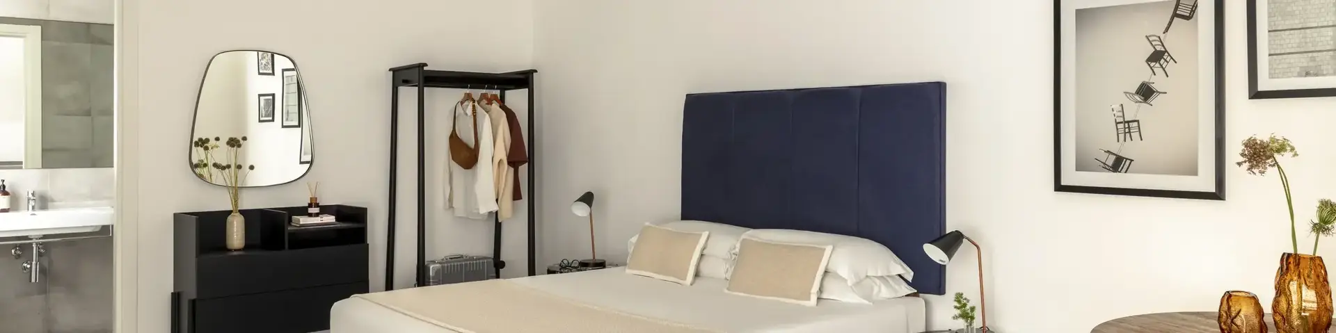 a bedroom with a bed and a mirror