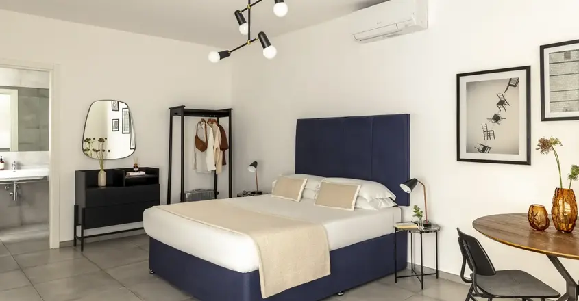 a bedroom with a bed and a mirror