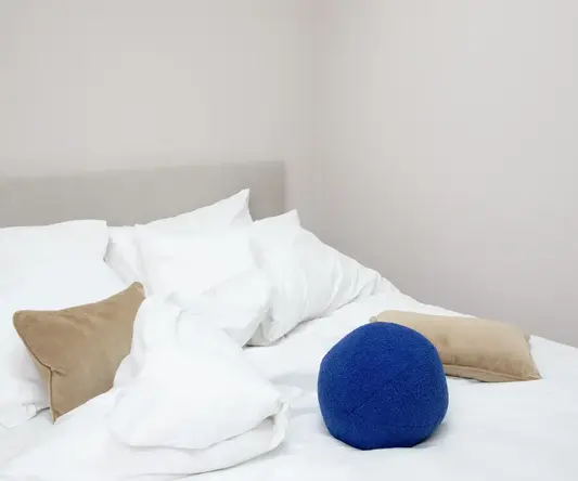 a blue ball on a bed